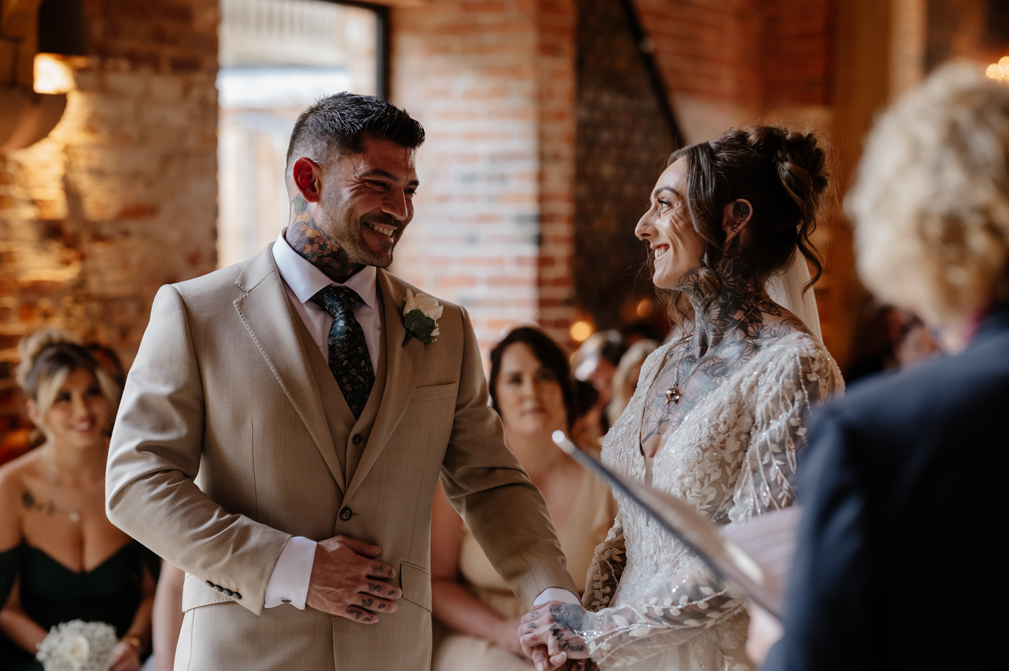 Bride and groom gazing at each other during their wedding ceremony at Shustoke Barn